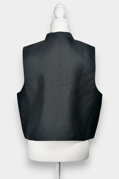 Women's black Song Brocade vest with a mandarin collar, frog buttons, and colorful woven traditional patterns on the hem.