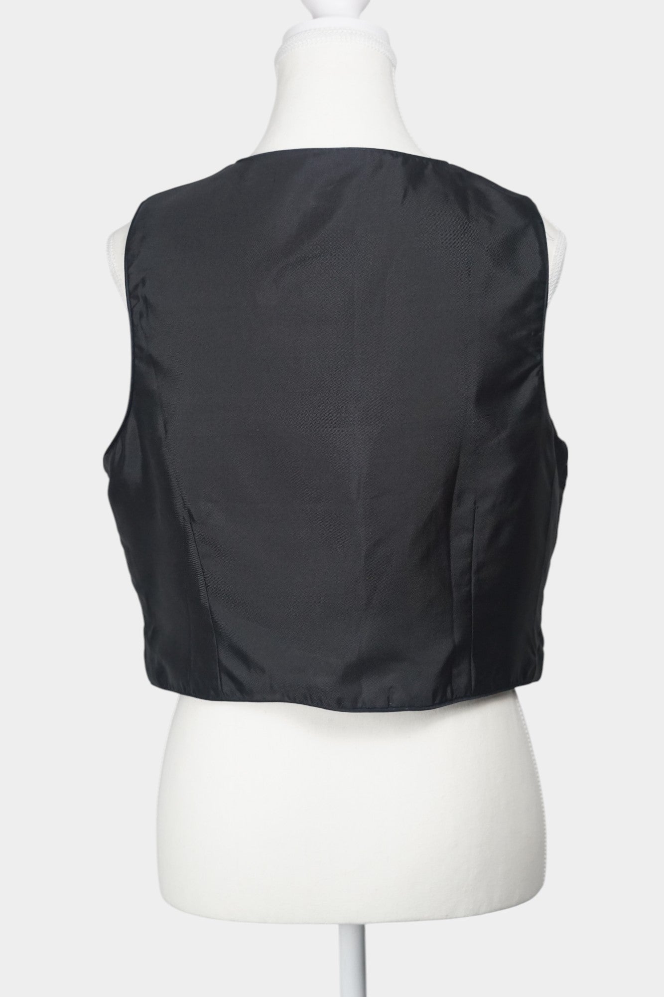 Black Song Brocade vest with V-neck, front tie closure, and white geometric hem details