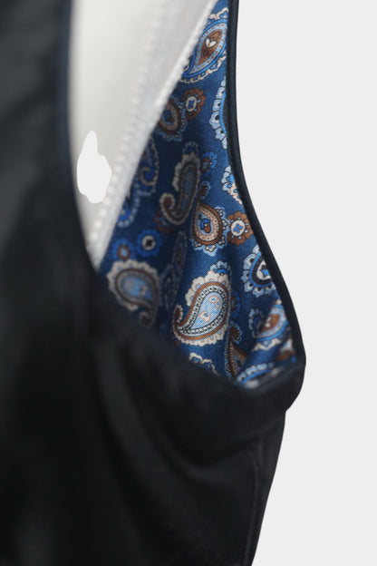 Black Song Brocade vest with V-neck, front tie closure, and white geometric hem details