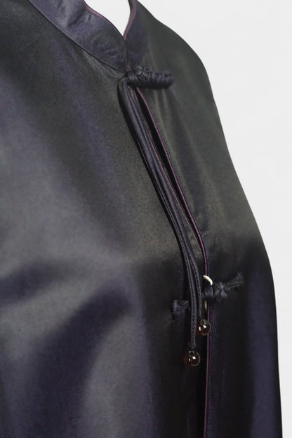 Women's dark purple Song Brocade vest with a mandarin collar, purple piping, and traditional frog buttons with tassels.