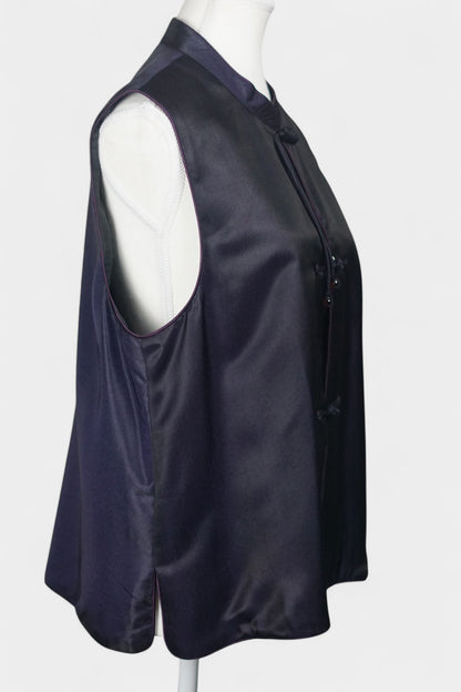 Women's dark purple Song Brocade vest with a mandarin collar, purple piping, and traditional frog buttons with tassels.