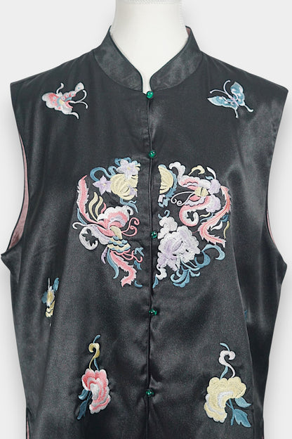 Traditional mandarin collar vest in black silk, adorned with pastel embroidered motifs of butterflies and mythical creatures
